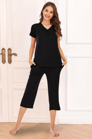 Black capri lounge set with gathered V-neck top and relaxed fit pants.