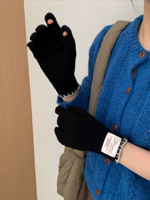 Black ribbed knit gloves with scalloped cuff and pink accents on fingertips.