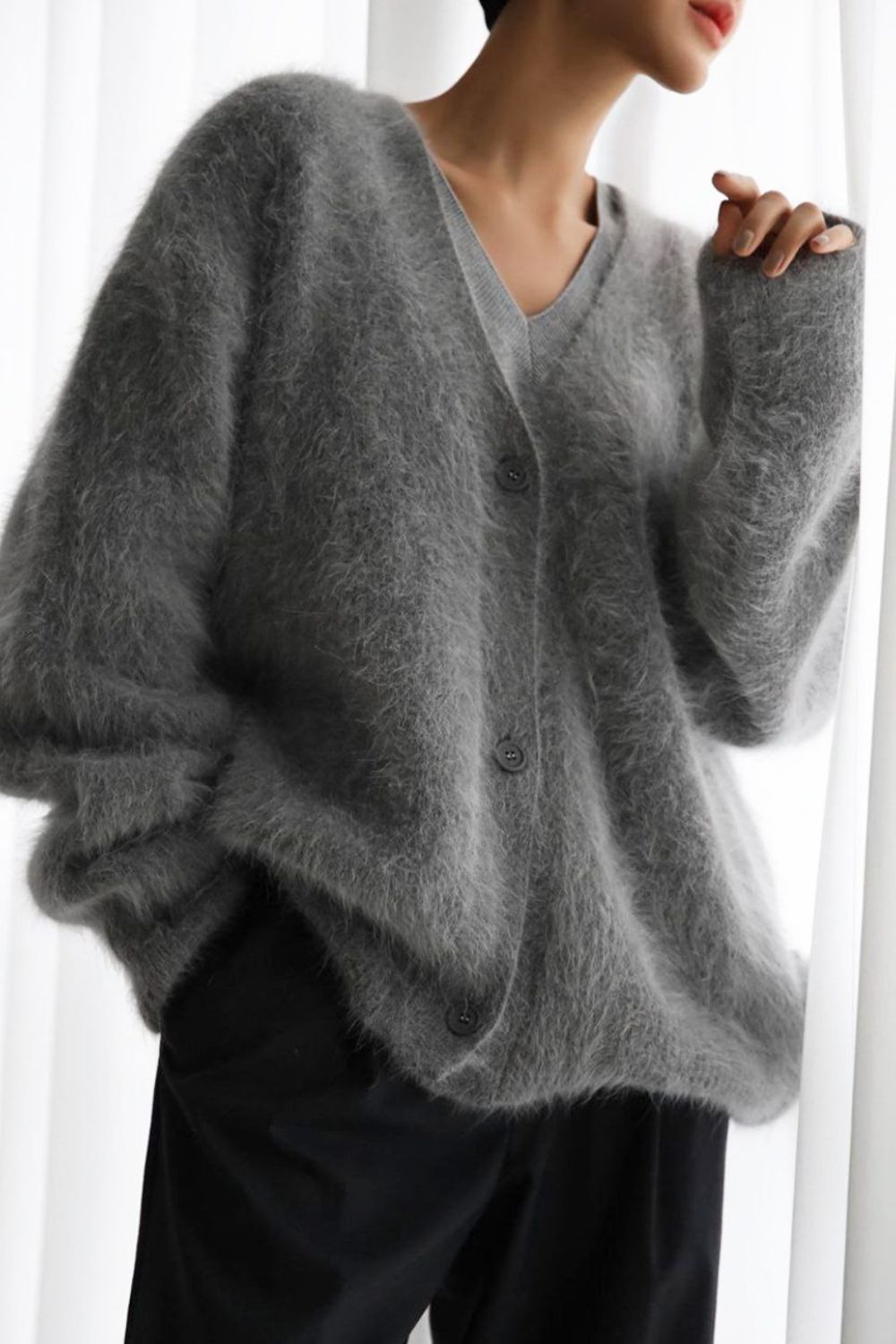 Dark gray angora button cardigan with sculpted sleeves and V-neck.