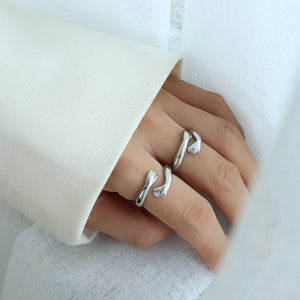 Silver embracing hands open ring, a chic accessory for women.