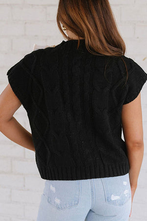 Black cable knit sweater tank with short sleeves and a mock neck.