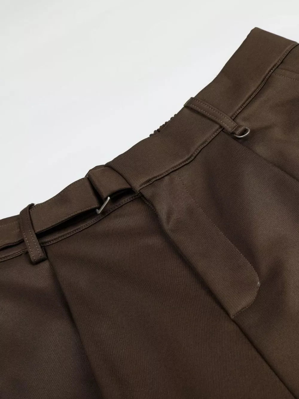 Brown pleated wide-leg capris with buckle detail and elastic waistband.