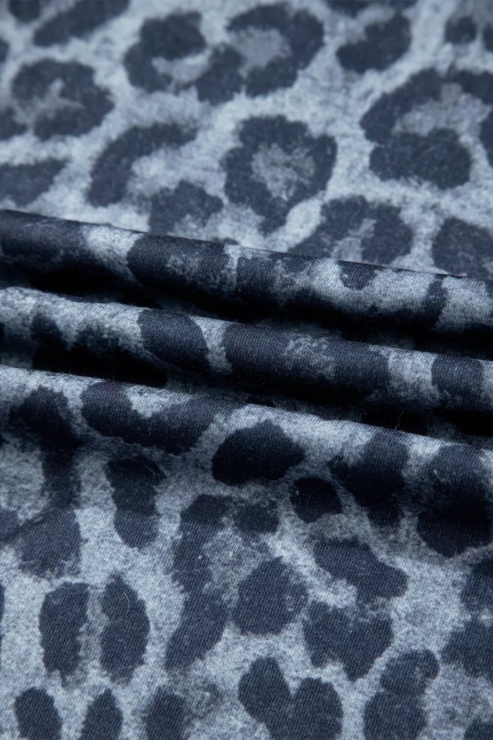 Maternity pants in dark navy with a grey leopard print and ruffled detail.