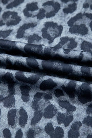 Maternity pants in dark navy with a grey leopard print and ruffled detail.