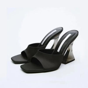 Black satin mules with square toe and clear sculpted heel