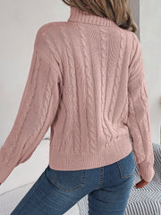 Dusty pink cable knit turtleneck sweater with voluminous sleeves and ribbed cuffs.