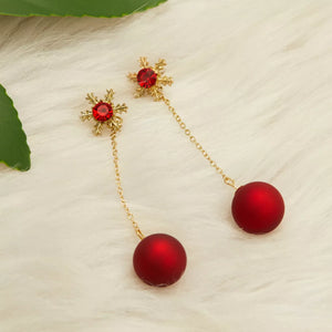 Deep red snowflake drop earrings with gold chain and red ball accent