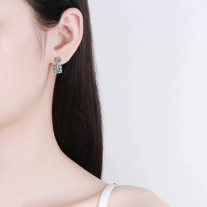 Silver double-drop cubic zirconia stud earrings with two round-cut stones.