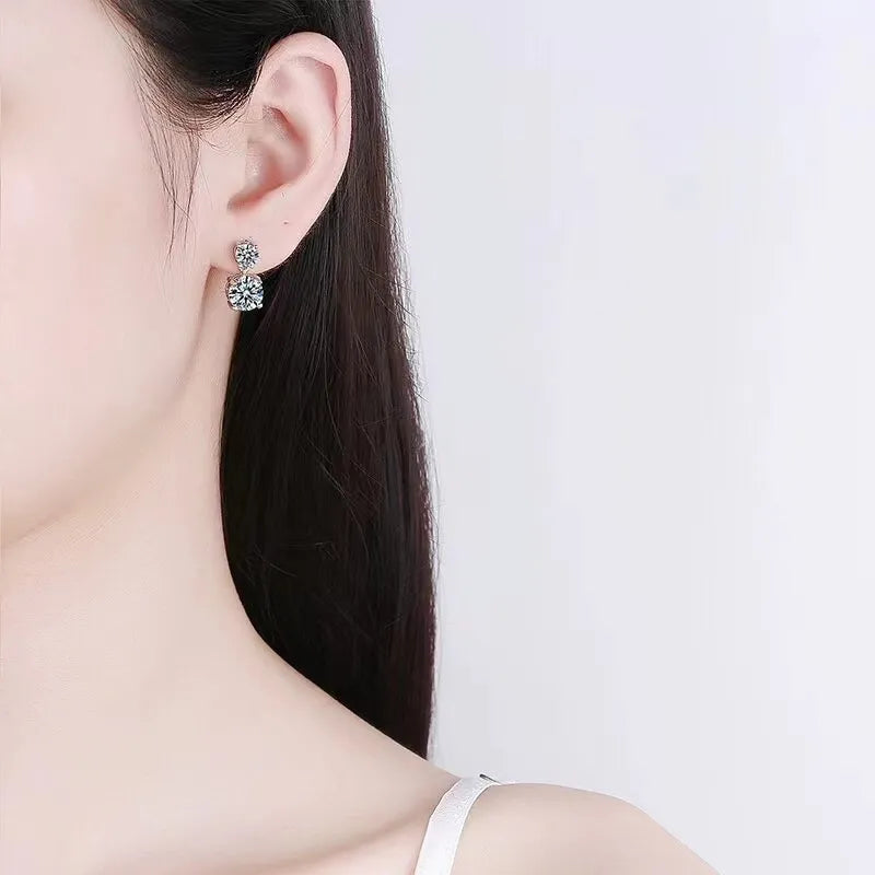 Silver double-drop cubic zirconia stud earrings with two round-cut stones.