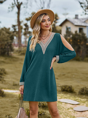 Teal cold shoulder mini dress with lace trim neckline and cuffs.