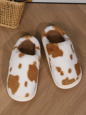 Cow print faux fur house slides in camel and white with brown accents.