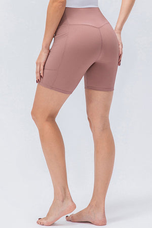 Dusty Pink ribbed bike shorts with pockets and a cross-waist detail.