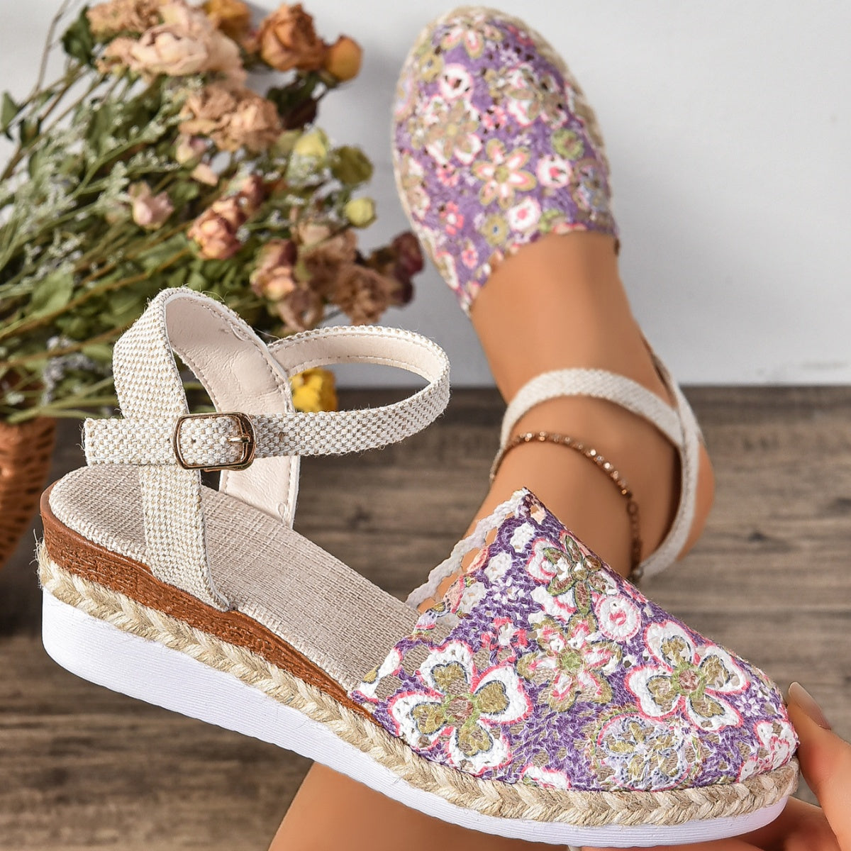 Purple floral espadrille sandals with ankle strap and buckle detail.