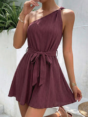 Chic one-shoulder tie waist romper in plum with textured fabric and a self-tie belt.