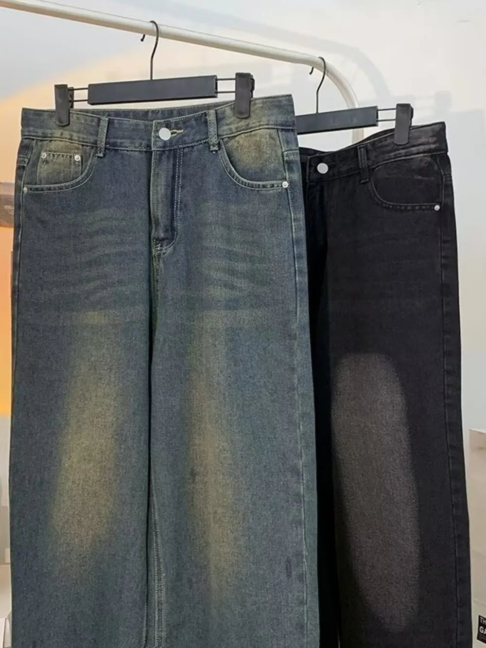 Men's plus-size vintage wash wide-leg jeans in medium blue and black denim.