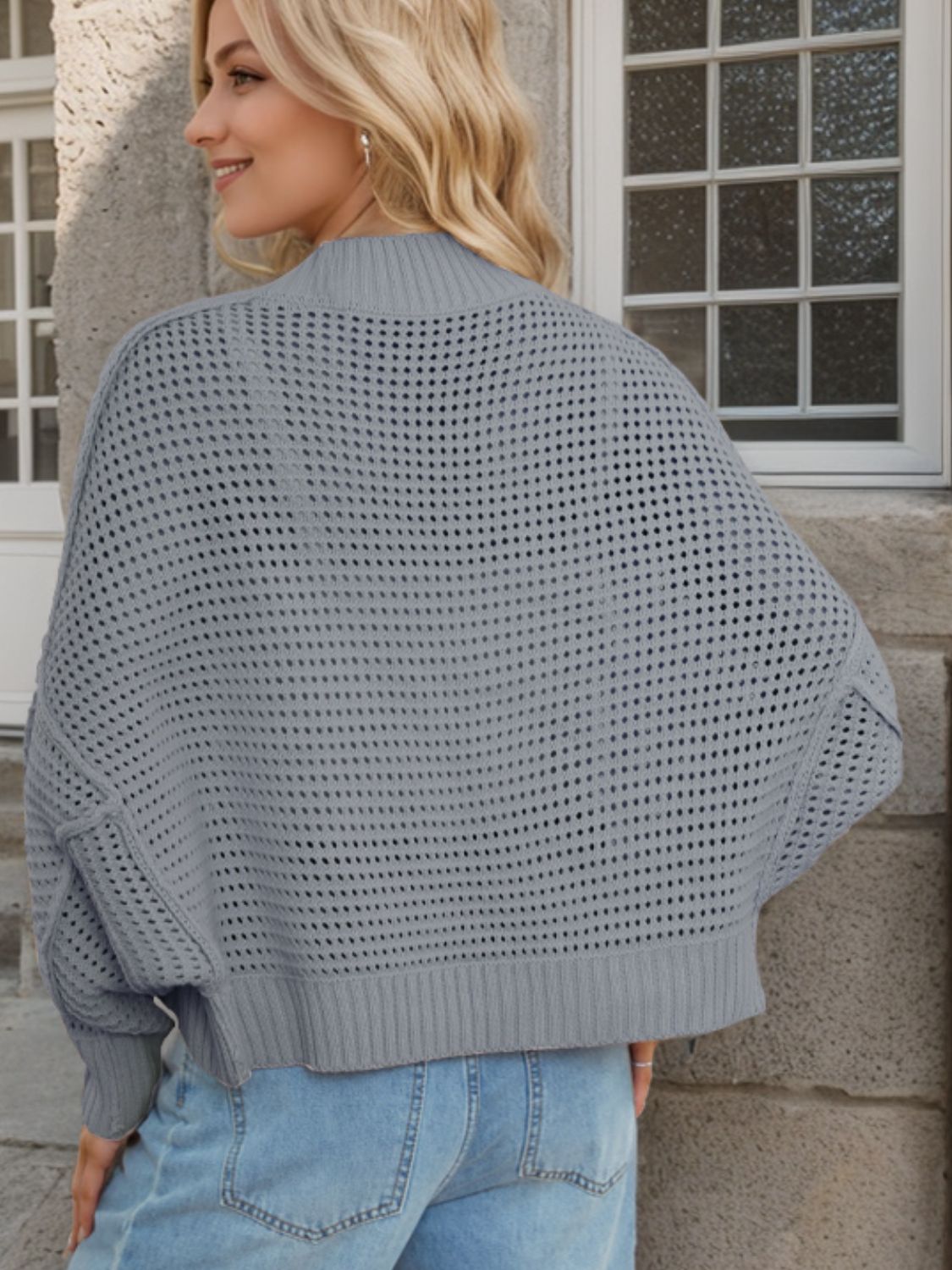 Open-knit boxy cardigan in dark gray with sculpted collar and ribbed hem.