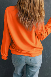 Orange crewneck sweatshirt with long sleeves and a relaxed fit.