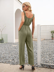 Matcha green textured wide-leg jumpsuit with ruffled straps and cinched waist.