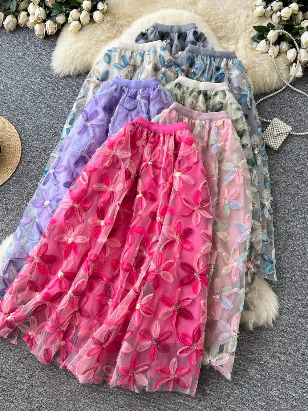 Layered floral embroidered midi skirt in pink, purple, gray, and apricot blue flower colors.