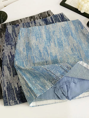 Light blue sequin mini skirt with vertical stripe pattern and zipper detail.