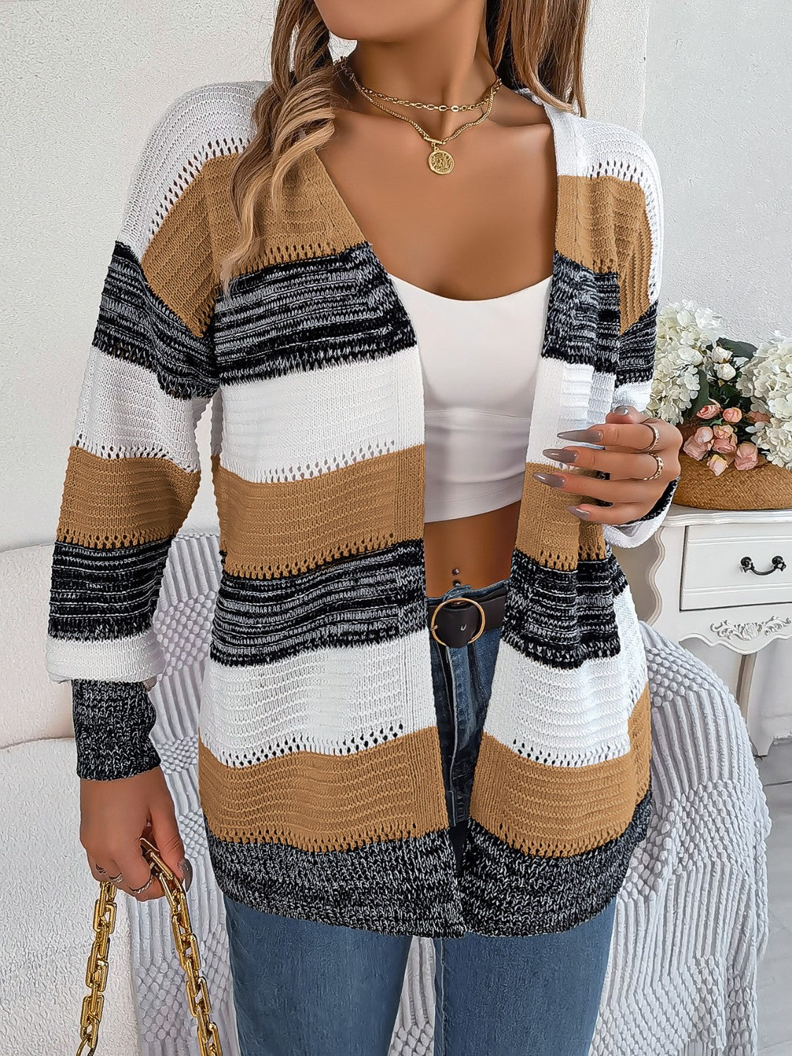 Open-front knit cardigan with horizontal stripes in camel, white, black, and gray acrylic.