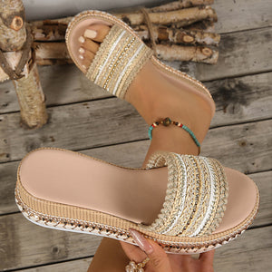Embellished open-toe platform sandals with woven straps and beaded trim.