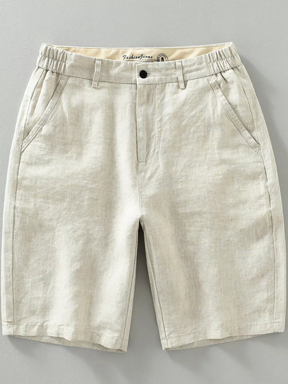 Beige lightweight chino shorts with elastic waistband and pockets.