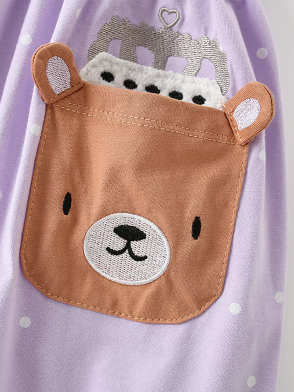 Lavender polka dot cotton dress with a brown bear applique pocket and crown detail.