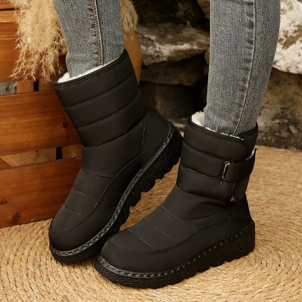 Black quilted round toe platform boots with adjustable strap and white lining.