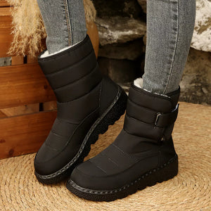 Black quilted round toe platform boots with adjustable strap and white lining.