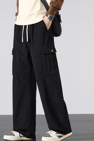 Black relaxed fit cargo sweatpants with drawstring and button-flap pockets.