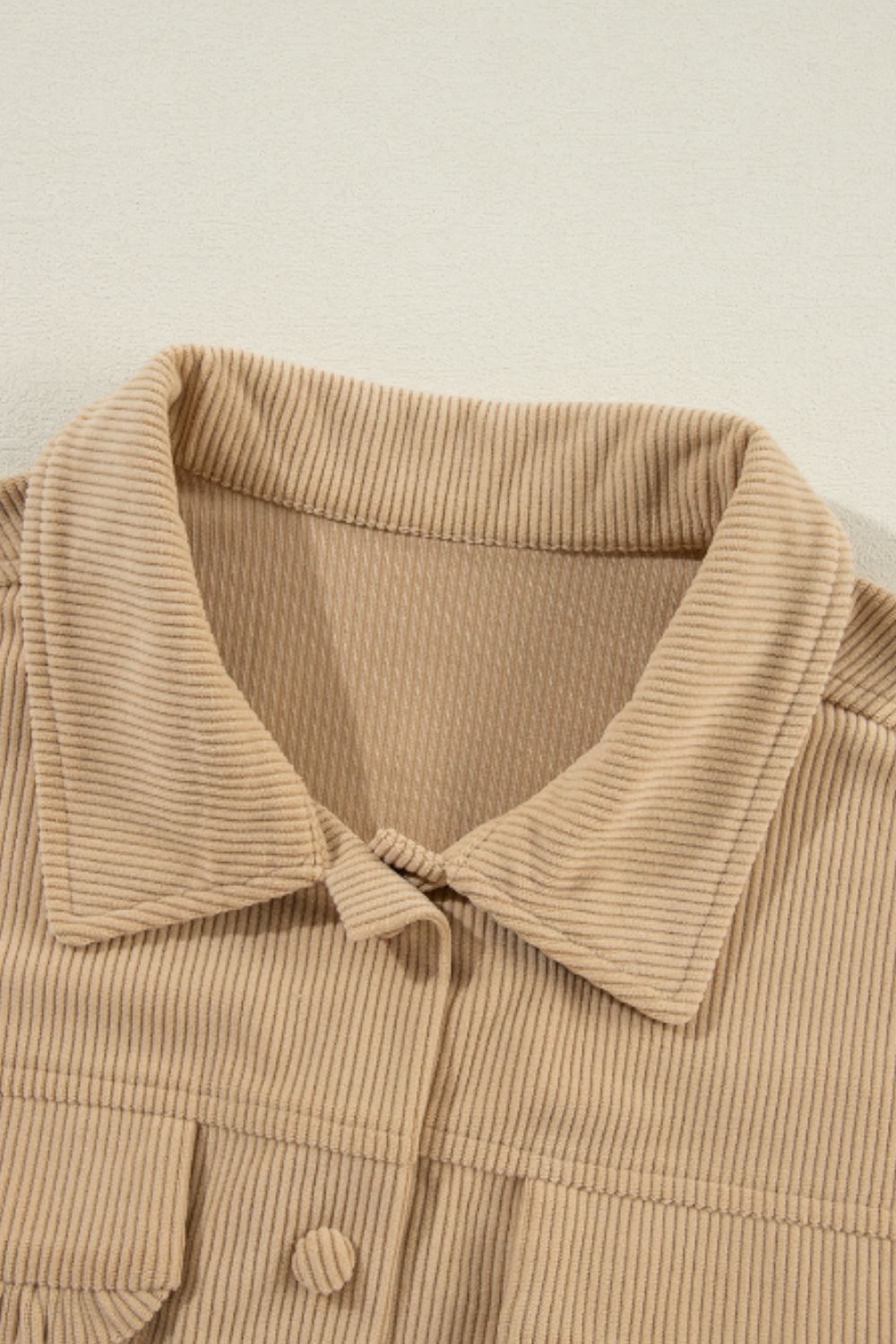 Tan corduroy utility shirt with ruffled pockets and button front detail.