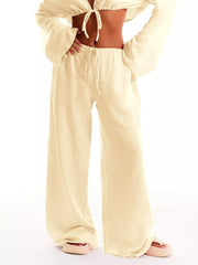 Pastel yellow relaxed wide-leg maternity pants with drawstring waist.