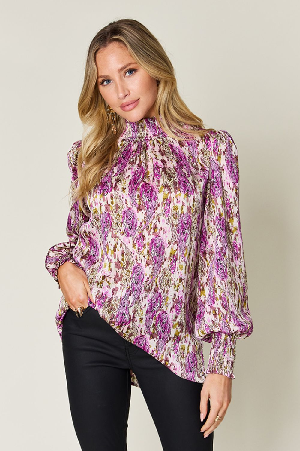 High neck abstract print blouse in red-violet with long puff sleeves and smocked cuffs.