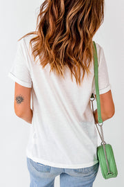 White casual t-shirt with rolled sleeves and a faded graphic print on the arm.