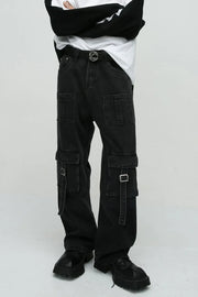 Dark utility denim cargo pants with buckle pockets and a statement belt.