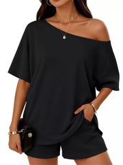Black asymmetrical one-shoulder top with pockets and matching shorts set.