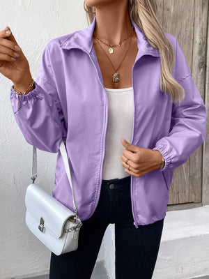 Lavender nylon bomber jacket with drawstring hem and elastic cuffs.