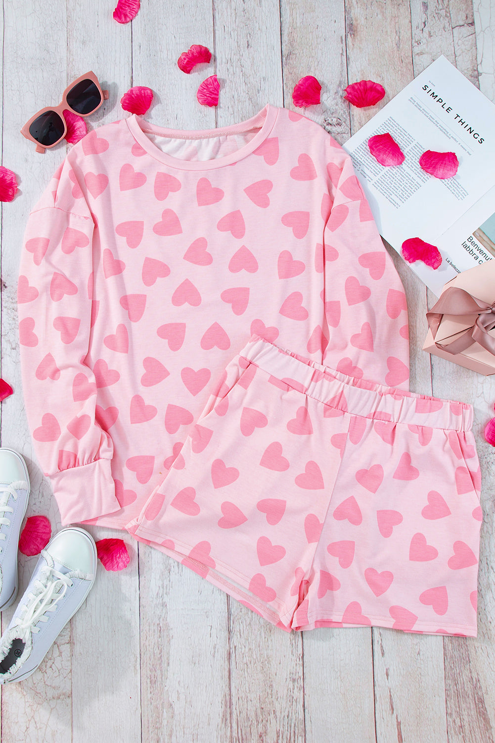 Blush pink heart print pajama set with long sleeve top and shorts.