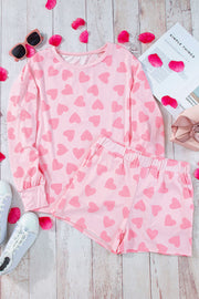 Blush pink heart print pajama set with long sleeve top and shorts.