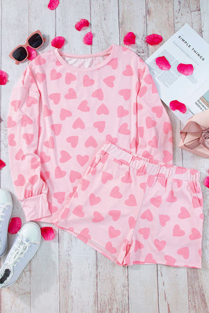 Blush pink heart print pajama set with long sleeve top and shorts.