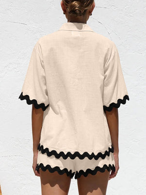 Tan pajama set with black scalloped trim on short sleeves and shorts.