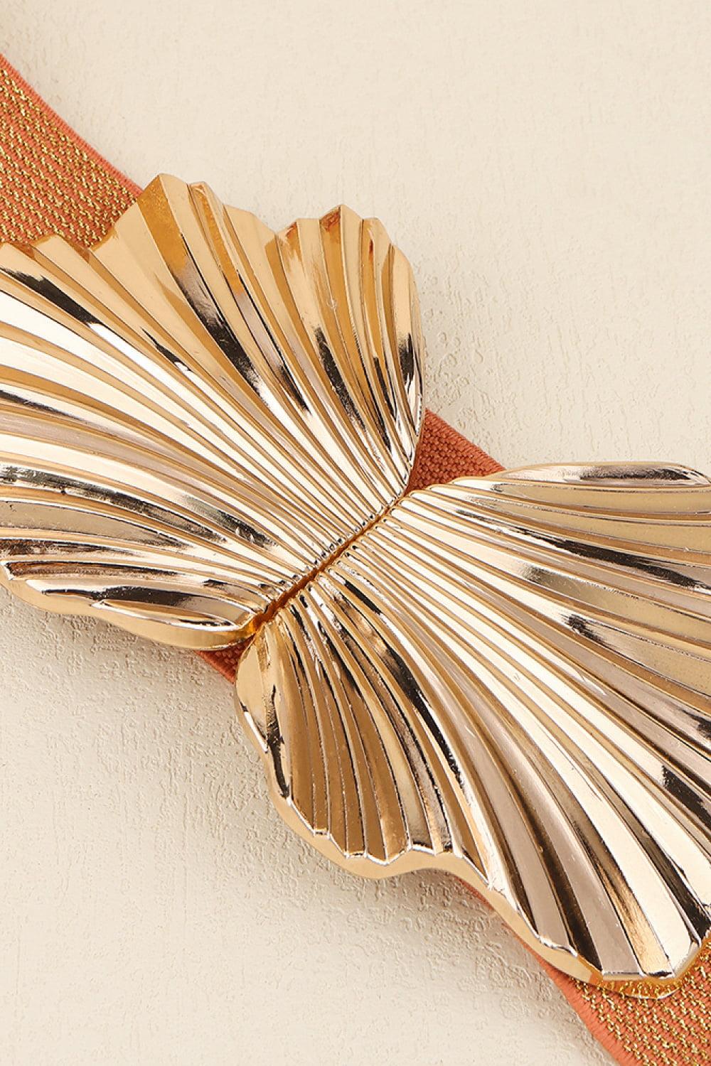 Caramel belt with sculpted gold butterfly buckle detail