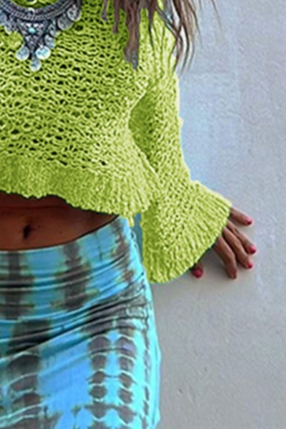 Lime crochet crop top with bell sleeves and frayed hem.