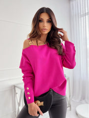 Hot Pink off-shoulder knit top with gold chain detail and button cuff.