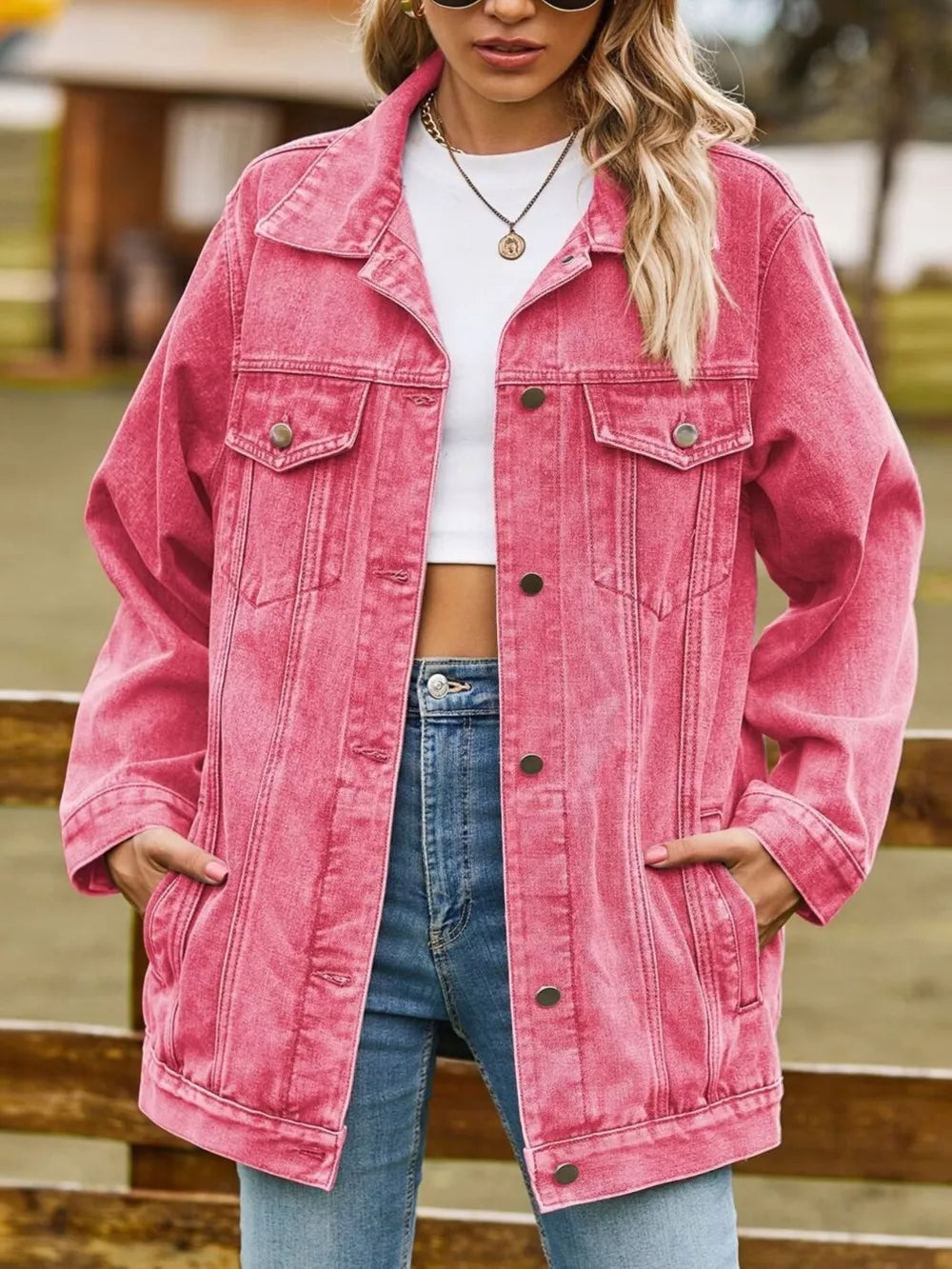 Relaxed fit washed denim trucker jacket in hot pink with button-down front and chest pockets.