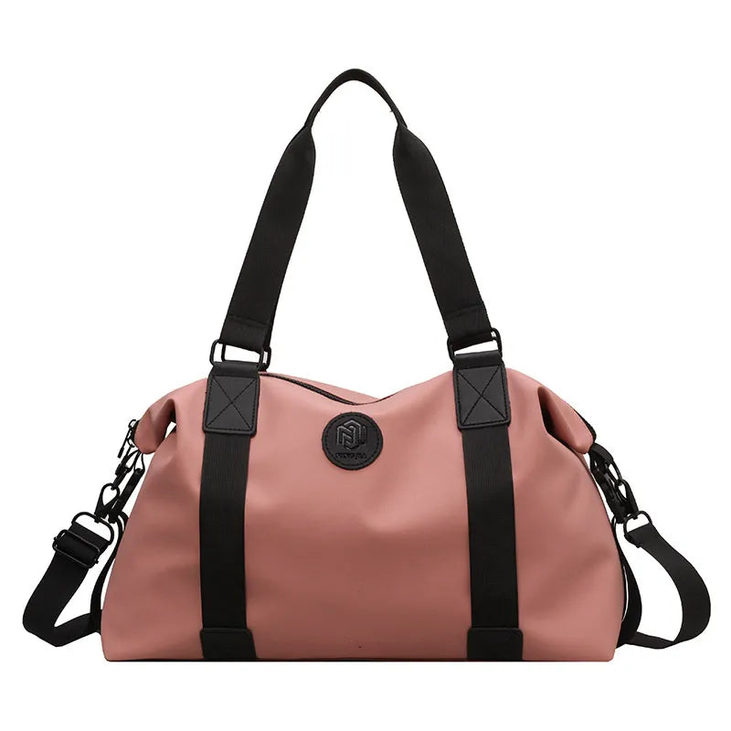 Dusty Pink duffel bag with black straps and logo detail, perfect for gym or travel.