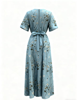 Teal floral maxi dress with short sleeves, defined waist tie, and back zipper.