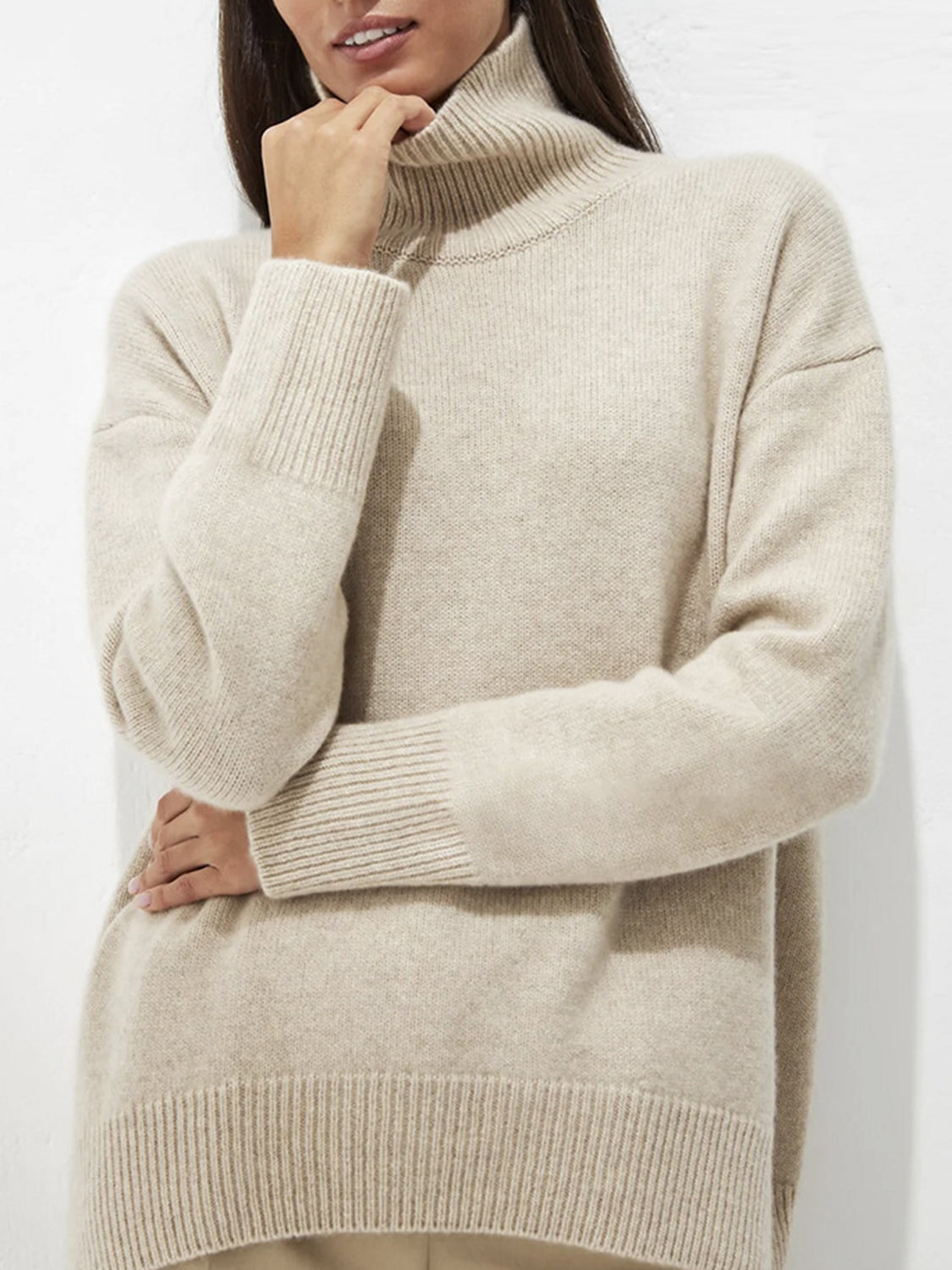 Relaxed turtleneck sweater in Ivory acrylic with sculptural sleeves and ribbed cuffs.
