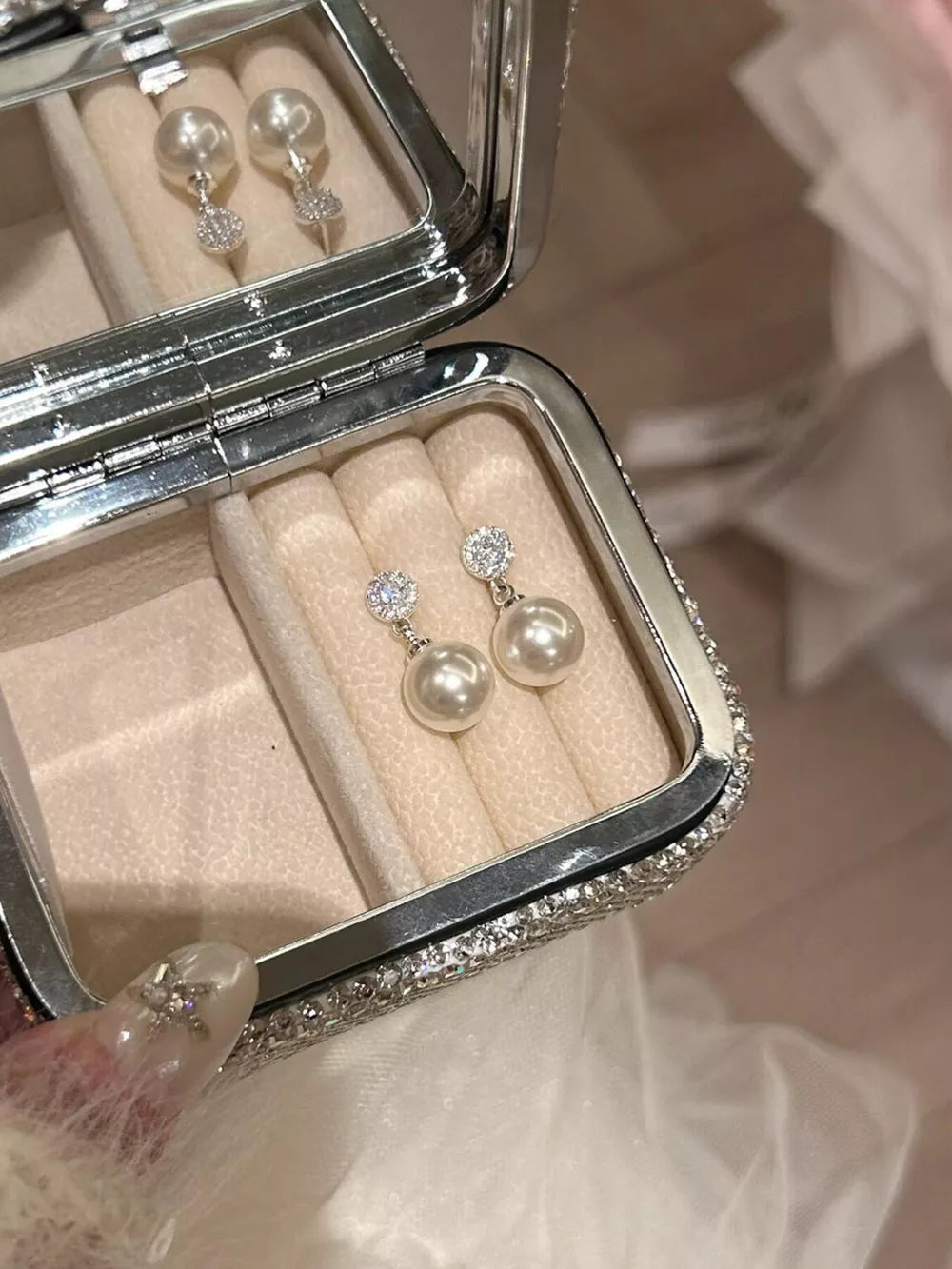 Pearl drop earrings with zircon accents in a jewelry box